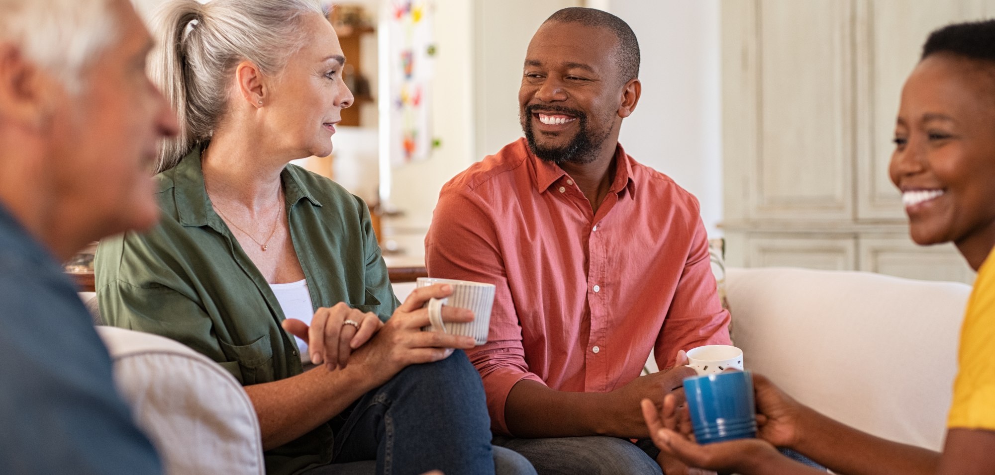 adults enjoying coffee conversation in a living 2