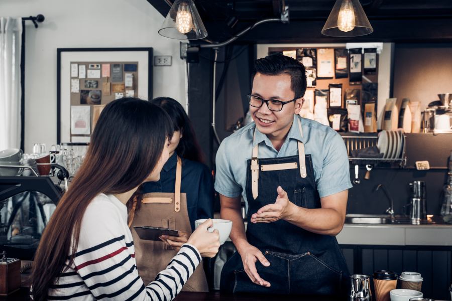 barista serving customers in a coffee shop